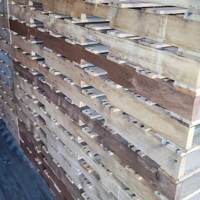 Stacked wooden pallets ready for recycling