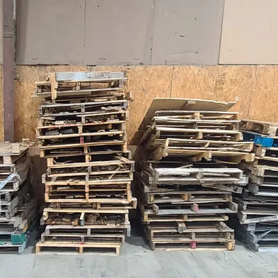 Stacked pallets against facility wall