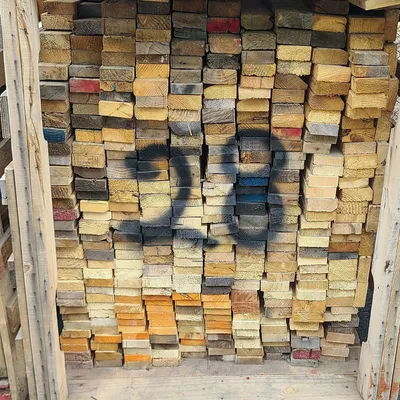 Pallet processing area with stacked wood